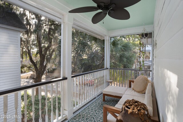 sunroom / solarium featuring ceiling fan