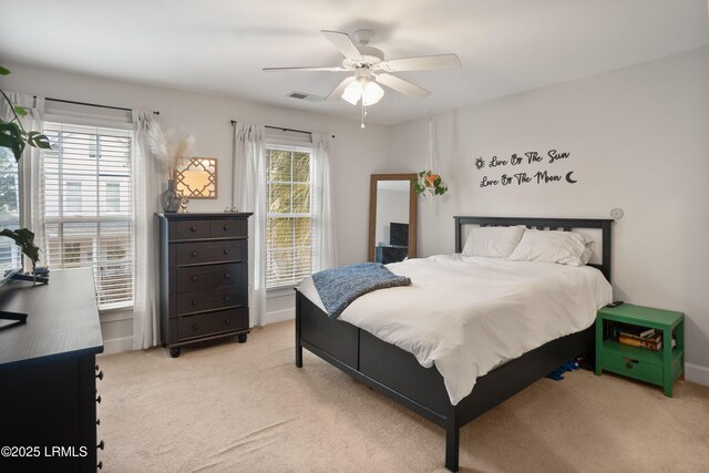 bedroom with ceiling fan and light carpet