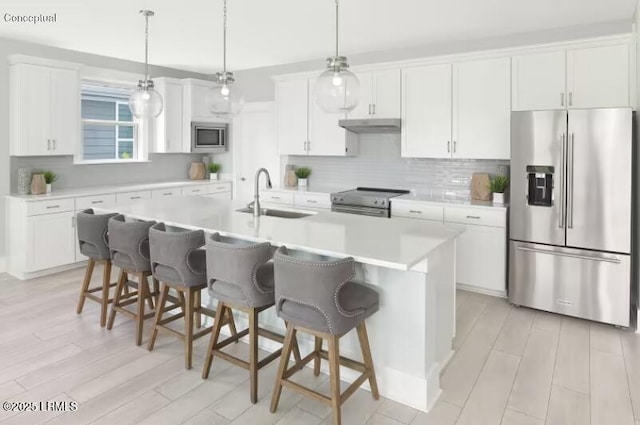 kitchen featuring a center island with sink, light countertops, appliances with stainless steel finishes, white cabinets, and a sink