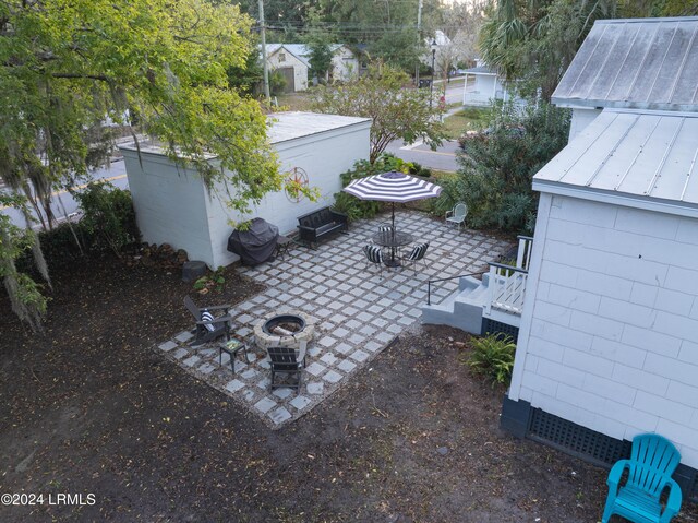 view of patio / terrace featuring cooling unit and an outdoor fire pit