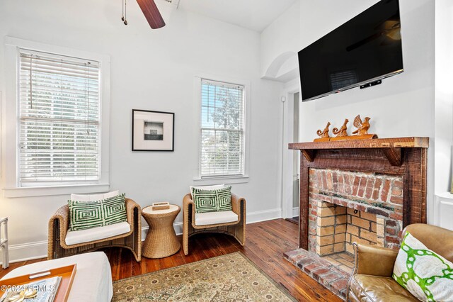 living room with hardwood / wood-style flooring, a fireplace, and ceiling fan