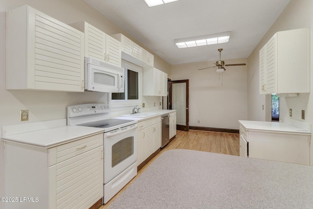 1 Royal James Dr, Hilton Head Island, SC 29926 - kitchen with white appliances, light wood-type flooring, a sink, and light countertops