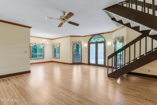 1 Royal James Dr, Hilton Head Island, SC 29926 - unfurnished living room with a chandelier, stairs, baseboards, ornamental molding, and a textured ceiling