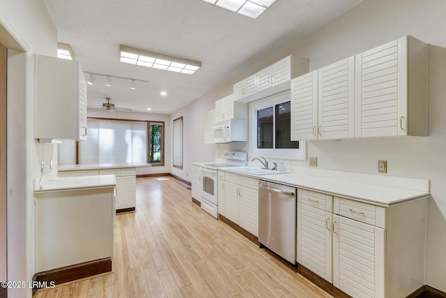 1 Royal James Dr, Hilton Head Island, SC 29926 - kitchen featuring white appliances, light countertops, light wood-type flooring, and a sink
