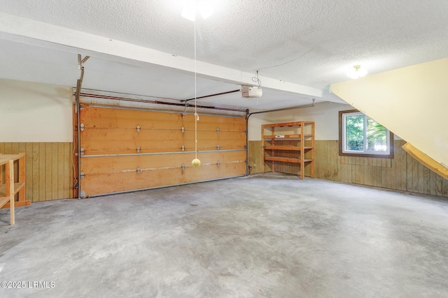 1 Royal James Dr, Hilton Head Island, SC 29926 - garage featuring a garage door opener, wood walls, and wainscoting