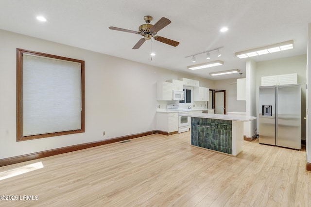 1 Royal James Dr, Hilton Head Island, SC 29926 - kitchen with white appliances, white cabinets, light countertops, light wood-type flooring, and baseboards