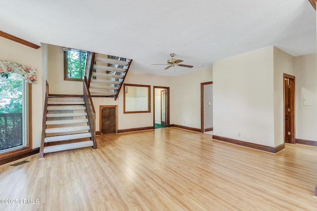 1 Royal James Dr, Hilton Head Island, SC 29926 - unfurnished living room with light wood-style floors, stairs, a ceiling fan, and baseboards