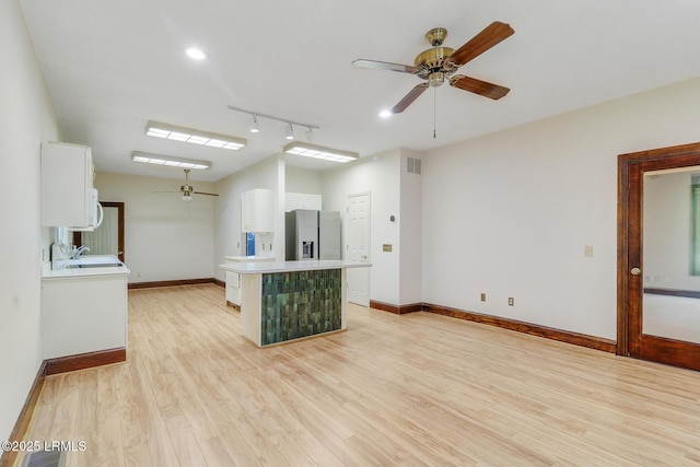 1 Royal James Dr, Hilton Head Island, SC 29926 - unfurnished living room featuring ceiling fan, light wood finished floors, baseboards, and rail lighting