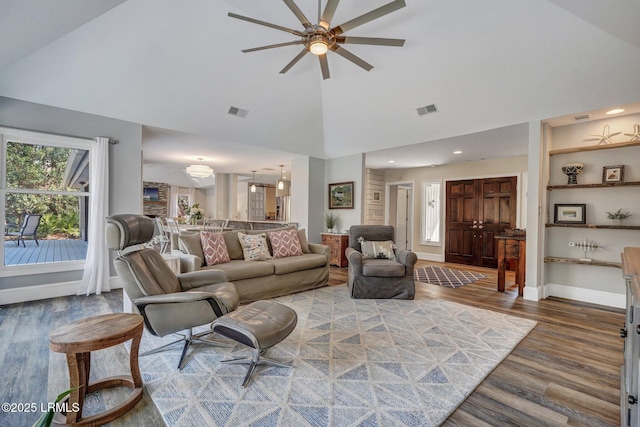 living room with hardwood / wood-style floors, high vaulted ceiling, and ceiling fan