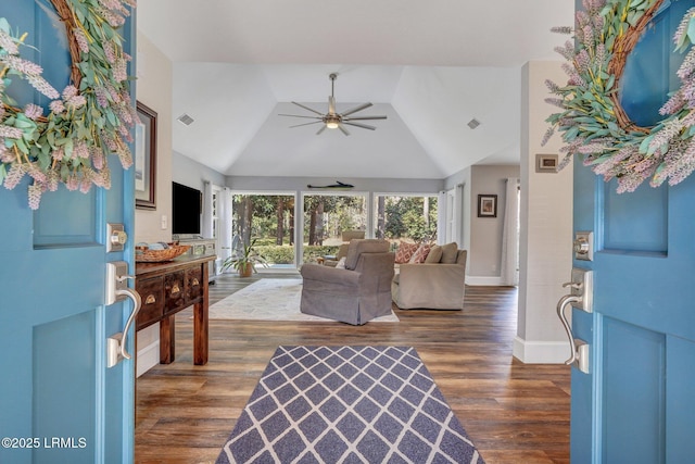 living room featuring lofted ceiling, dark wood-type flooring, and ceiling fan