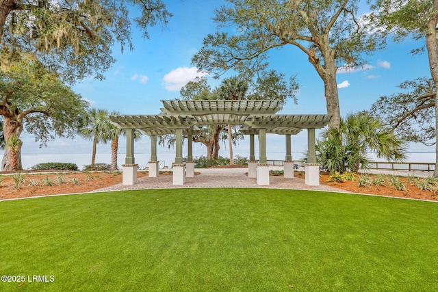 view of yard with a water view and a pergola