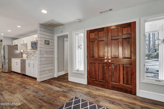 foyer entrance featuring dark hardwood / wood-style floors