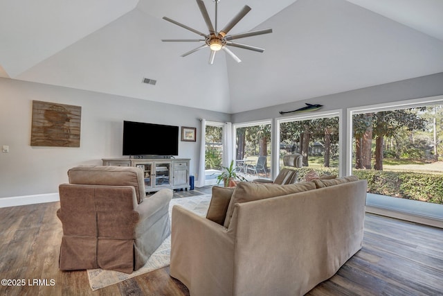 living room with hardwood / wood-style flooring, plenty of natural light, and high vaulted ceiling