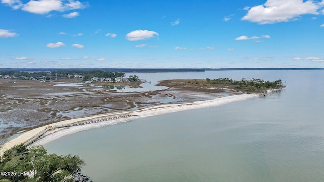 drone / aerial view featuring a water view and a view of the beach