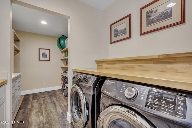 laundry room with independent washer and dryer and dark hardwood / wood-style floors