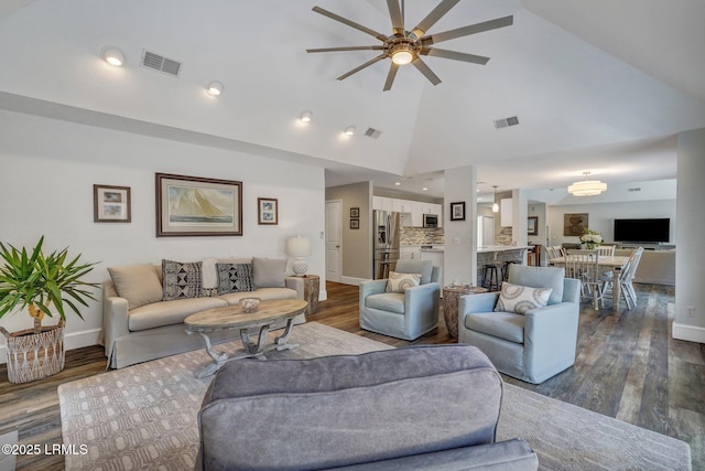 living room featuring wood-type flooring, ceiling fan, and high vaulted ceiling