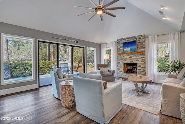 living room featuring ceiling fan, high vaulted ceiling, dark wood-type flooring, and a fireplace