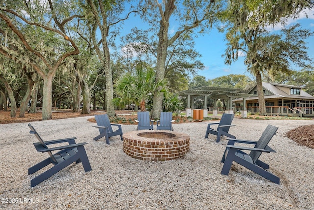 view of community featuring a pergola and an outdoor fire pit