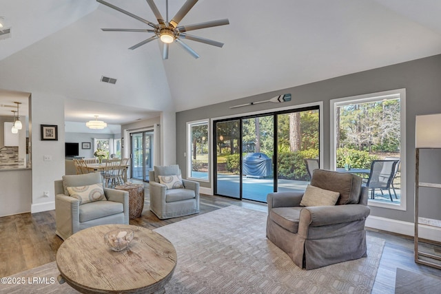 living room featuring hardwood / wood-style floors and high vaulted ceiling