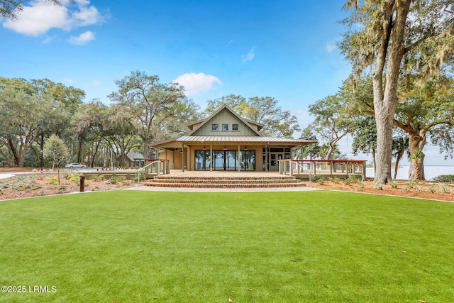 rear view of property featuring a yard