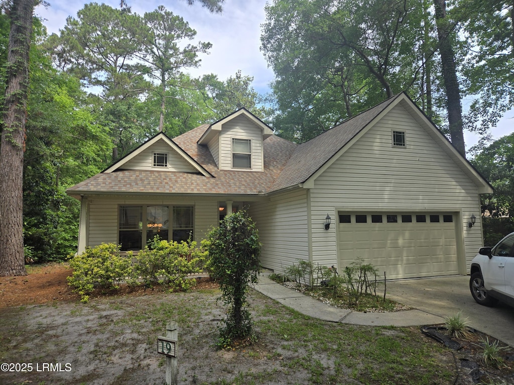 19 Celosia Ln, Hilton Head Island, SC 29926 - view of front of house with a shingled roof, concrete driveway, and a garage