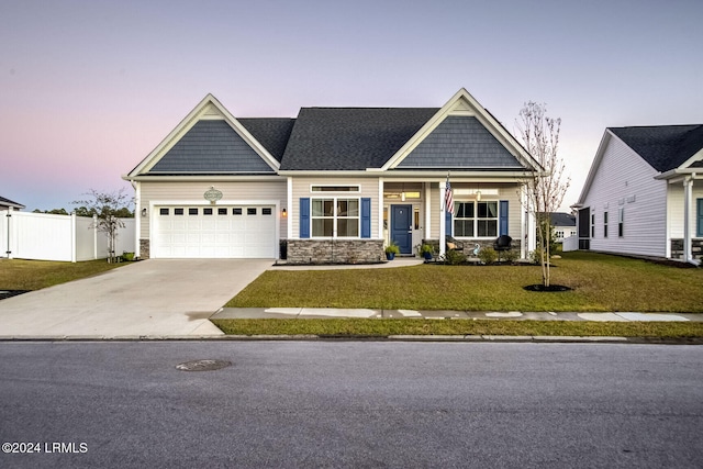 craftsman-style house with a garage and a yard