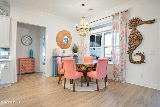 dining space featuring a notable chandelier, ornamental molding, and light wood-type flooring