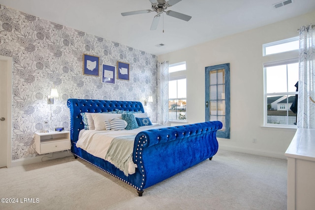 bedroom featuring light colored carpet and ceiling fan