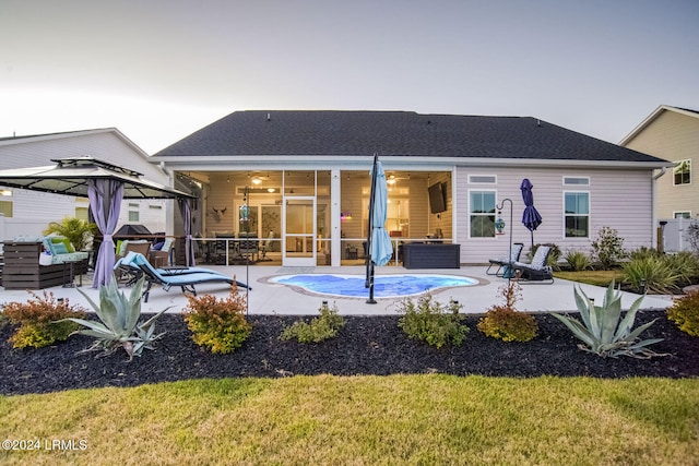 rear view of house with a gazebo and a patio area