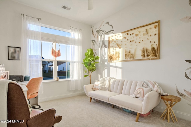 living area featuring light carpet