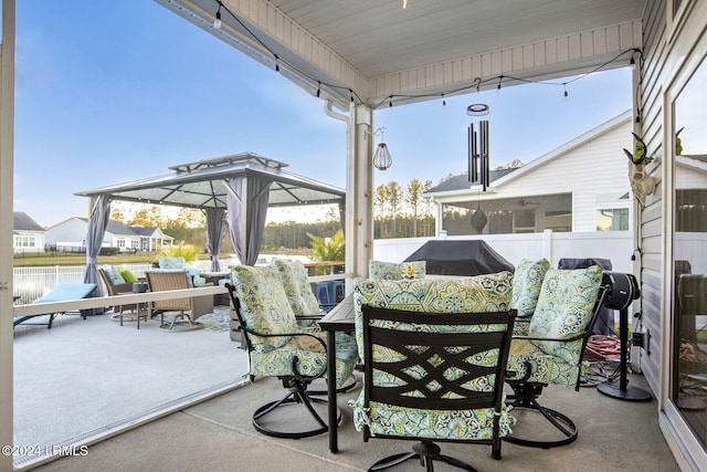 view of patio / terrace featuring a gazebo, a water view, and a grill