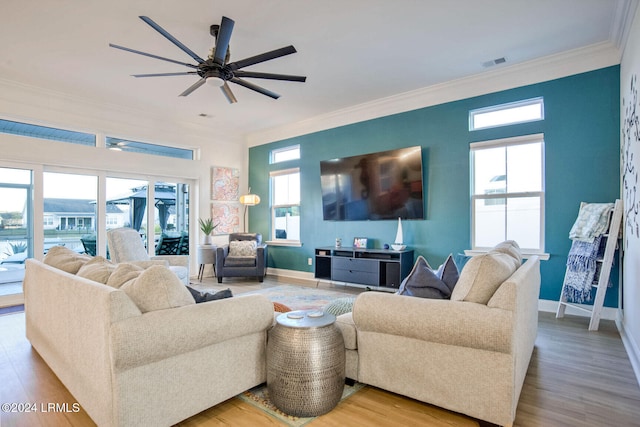 living room with ceiling fan, ornamental molding, and light hardwood / wood-style flooring