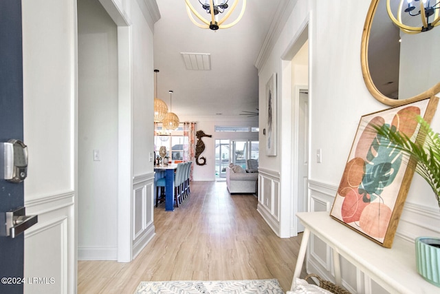 hall featuring crown molding and light hardwood / wood-style flooring