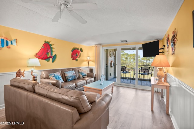167 Beach Club Villa Dr Unit 167, Fripp Island, SC 29920 - living area with wood finished floors, wainscoting, a textured ceiling, ceiling fan, and lofted ceiling