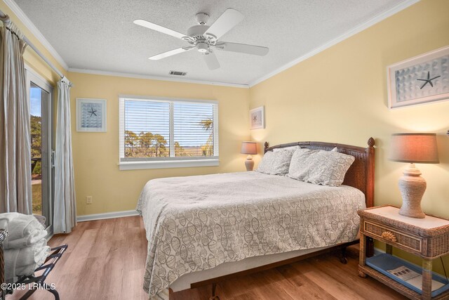 167 Beach Club Villa Dr Unit 167, Fripp Island, SC 29920 - bedroom featuring wood finished floors, access to outside, ornamental molding, a textured ceiling, and ceiling fan