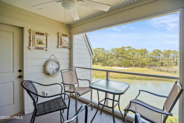 167 Beach Club Villa Dr Unit 167, Fripp Island, SC 29920 - balcony featuring a ceiling fan and view of scattered trees