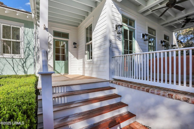 entrance to property featuring a porch and ceiling fan