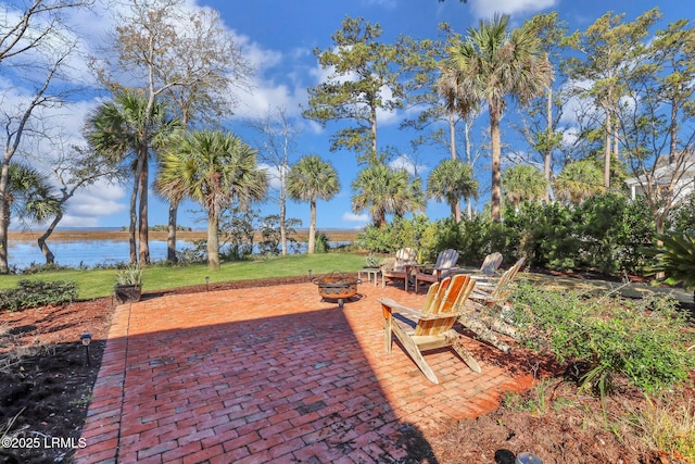 view of patio featuring a water view and an outdoor fire pit