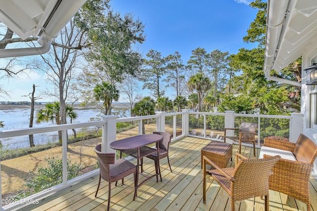 wooden terrace featuring a water view