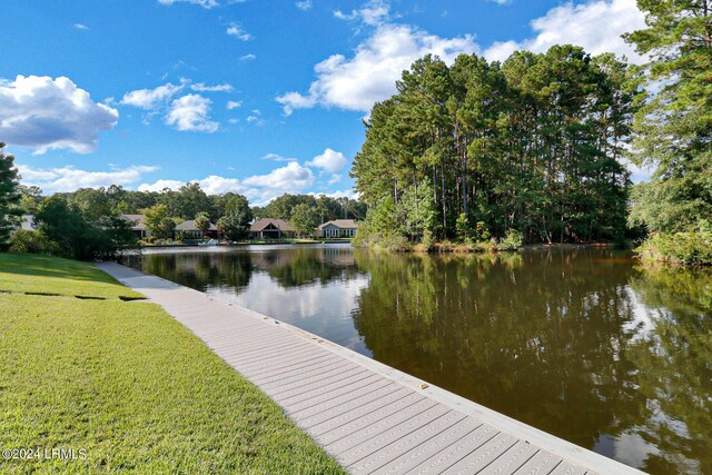 view of dock featuring a water view and a lawn