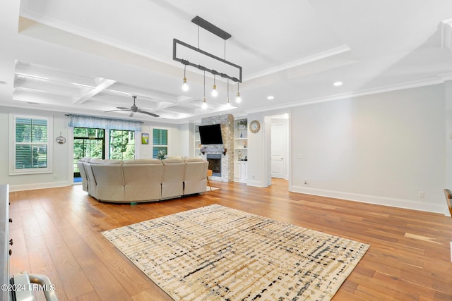 unfurnished living room featuring coffered ceiling, a stone fireplace, light hardwood / wood-style flooring, and built in features