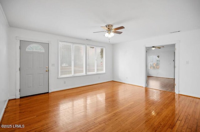 foyer entrance featuring ceiling fan and wood-type flooring