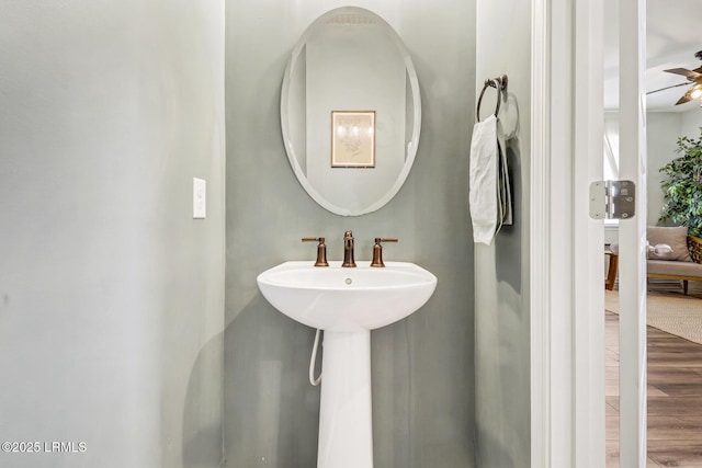 bathroom with a ceiling fan and wood finished floors