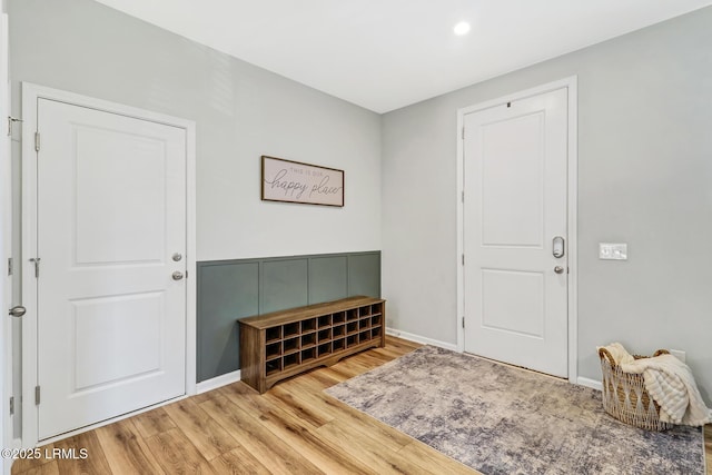 foyer featuring baseboards and wood finished floors