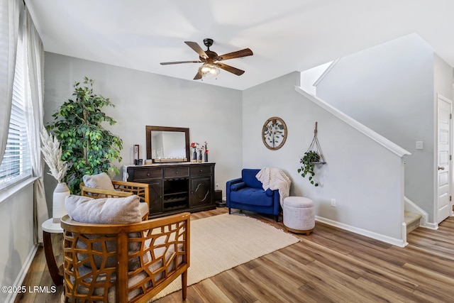 interior space featuring stairs, ceiling fan, wood finished floors, and baseboards