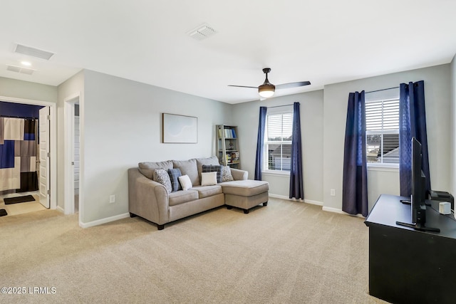 living room featuring light carpet, baseboards, and visible vents