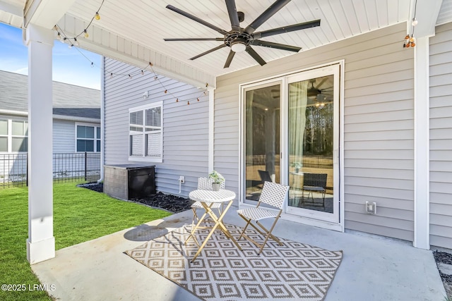 view of patio / terrace featuring fence and a ceiling fan