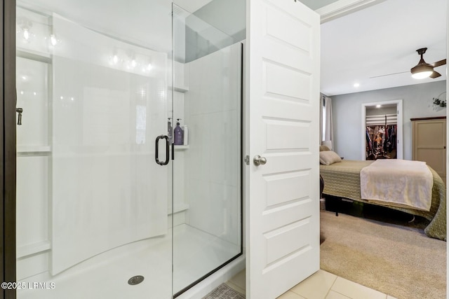 ensuite bathroom with ceiling fan, ensuite bath, a shower stall, and tile patterned floors