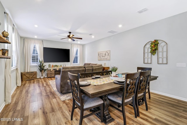 dining area with wood finished floors, visible vents, and recessed lighting