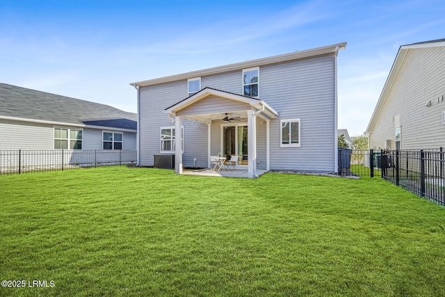 back of property with a yard, a patio area, a fenced backyard, and ceiling fan